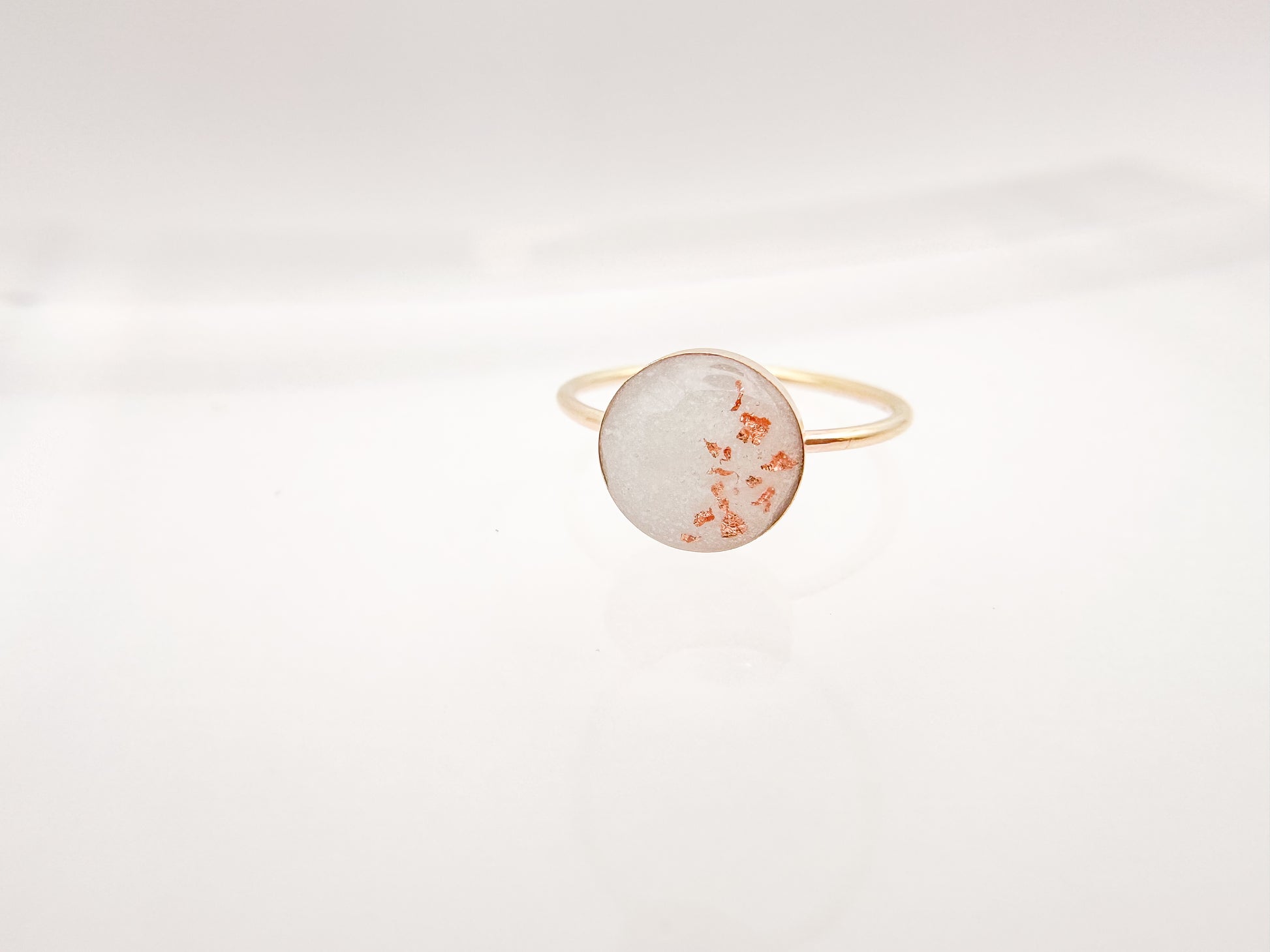 Gold ring with Breastmilk and copper flakes.